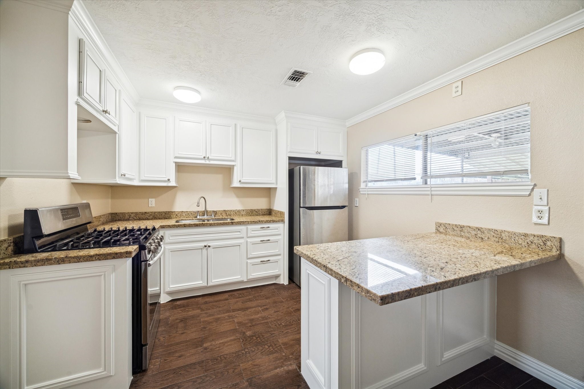 434 Meters Street Houston, TX 77020 - Photo 3 of 10 a kitchen with a sink stove and refrigerator