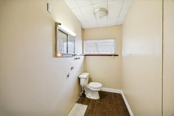 a bathroom with a toilet and a mirror