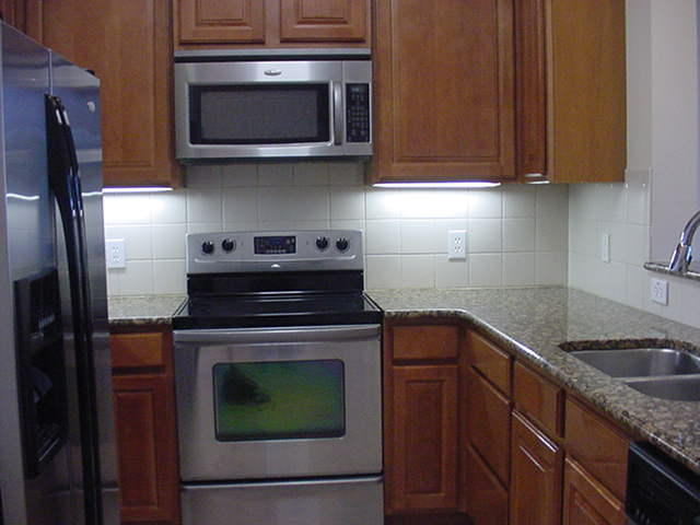 47 Bald Eagle Court Santa Rosa Beach, FL 32459 - Photo 5 of 26 a kitchen with stainless steel appliances granite countertop a stove microwave and refrigerator