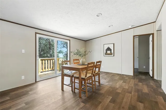 a dining room with furniture and wooden floor