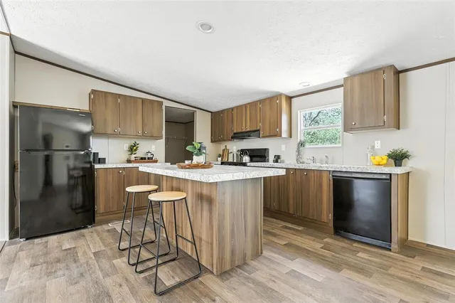 a kitchen with stainless steel appliances granite countertop a refrigerator sink and cabinets