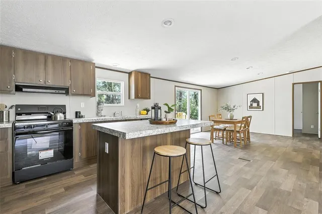 a kitchen with a stove a sink and a refrigerator