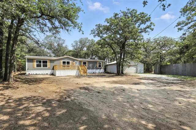 a front view of house with yard and trees