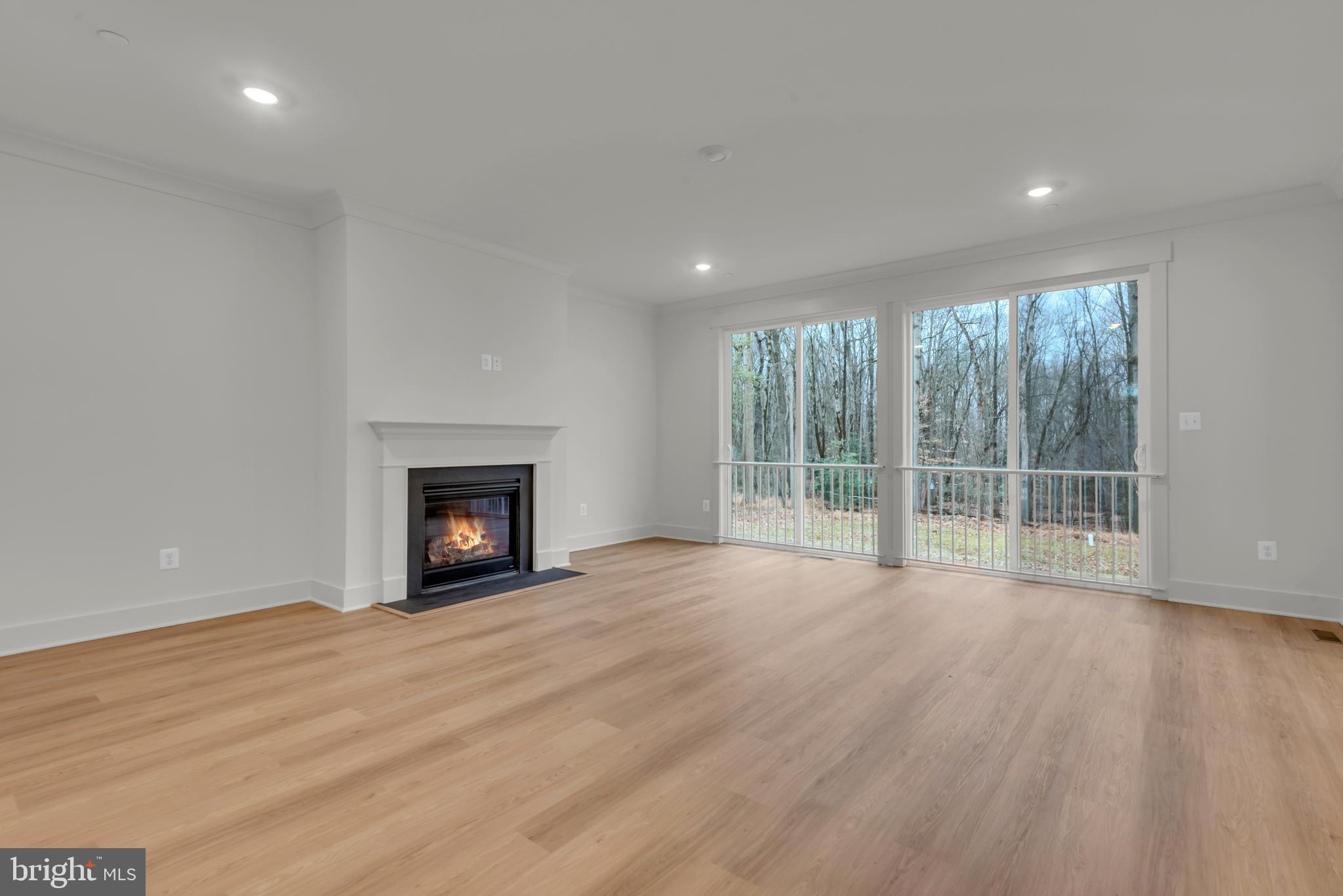 6502 Whitetail Xing Way Hanover, MD 21076 - Photo 7 of 58 a view of an empty room with wooden floor and a window