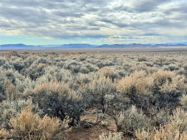 a view of an ocean beach and mountain