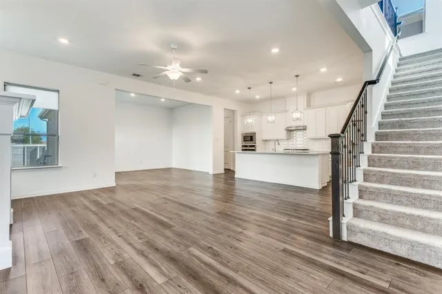 a view of kitchen and hall with wooden floor