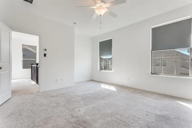 an empty room with windows and entrance