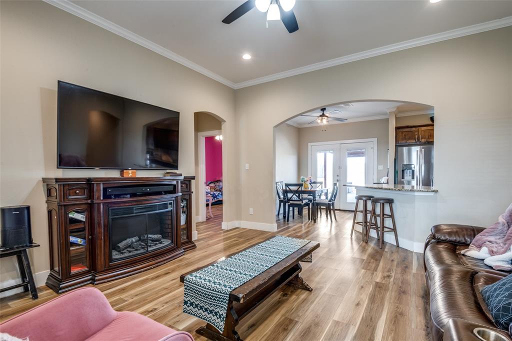 2234 Westpoint Circle Terrell, TX 75161 - Photo 11 of 25 Living room with crown molding, ceiling fan, and open layout connecting to the dining area and kitchen for easy flow.
