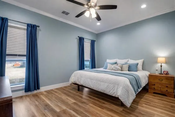 a bedroom with a large bed and a window