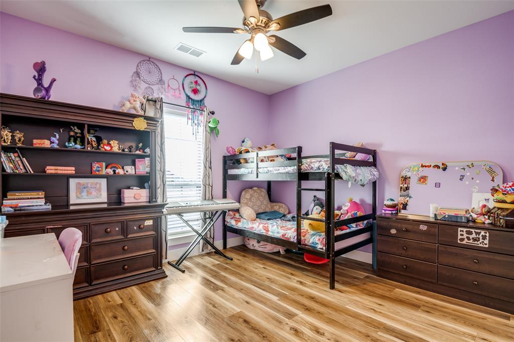 2234 Westpoint Circle Terrell, TX 75161 - Photo 20 of 25 Secondary bedroom with ceiling fan, natural light, and wood look flooring suitable for a variety of furniture layouts.