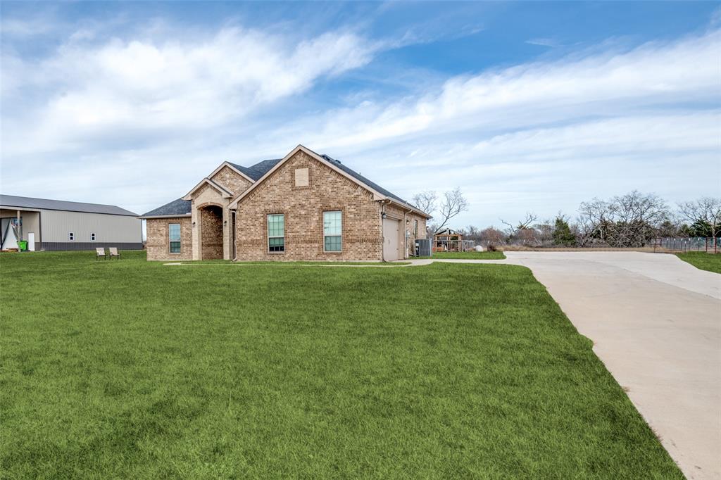 2234 Westpoint Circle Terrell, TX 75161 - Photo 2 of 25 All brick exterior with wide concrete driveway, covered front entry, and expansive yard offering room to enjoy the one acre setting.