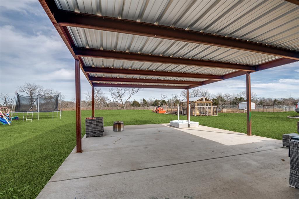 2234 Westpoint Circle Terrell, TX 75161 - Photo 22 of 25 Large 20 by 30 covered back patio with added concrete slab, stainless steel columns, and metal roof overlooking the one acreage.
