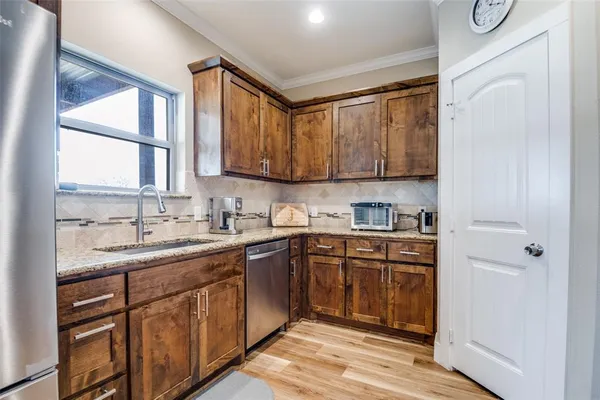 a kitchen with a sink stove and cabinets