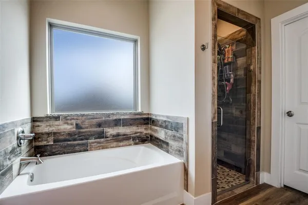a bathroom with a bathtub and a shower