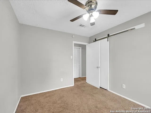 a view of a backyard with a tree