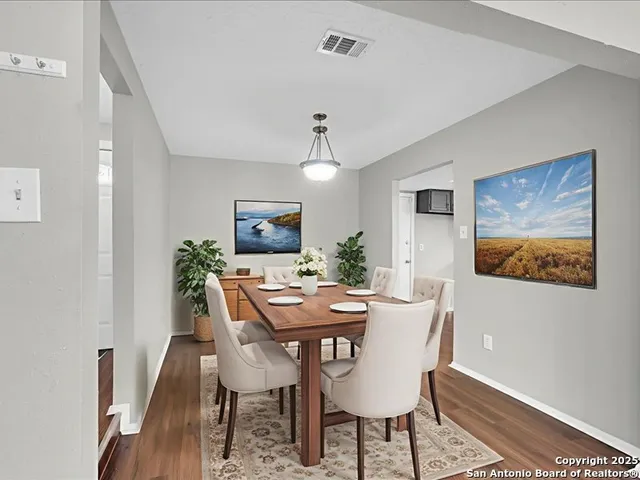a view of a dining room with furniture and wooden floor