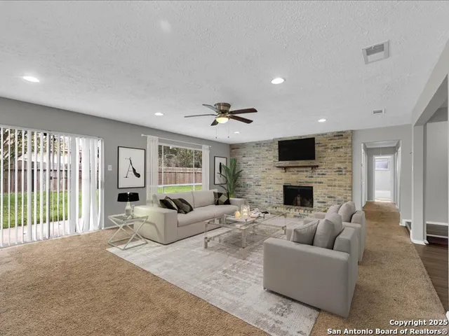a living room with fireplace furniture and a flat screen tv