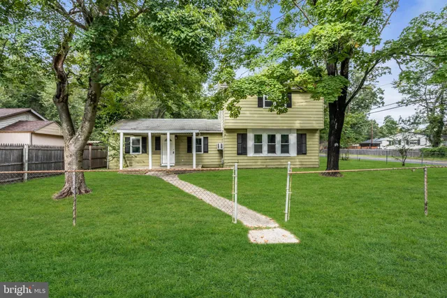 a front view of a house with a yard table and trees