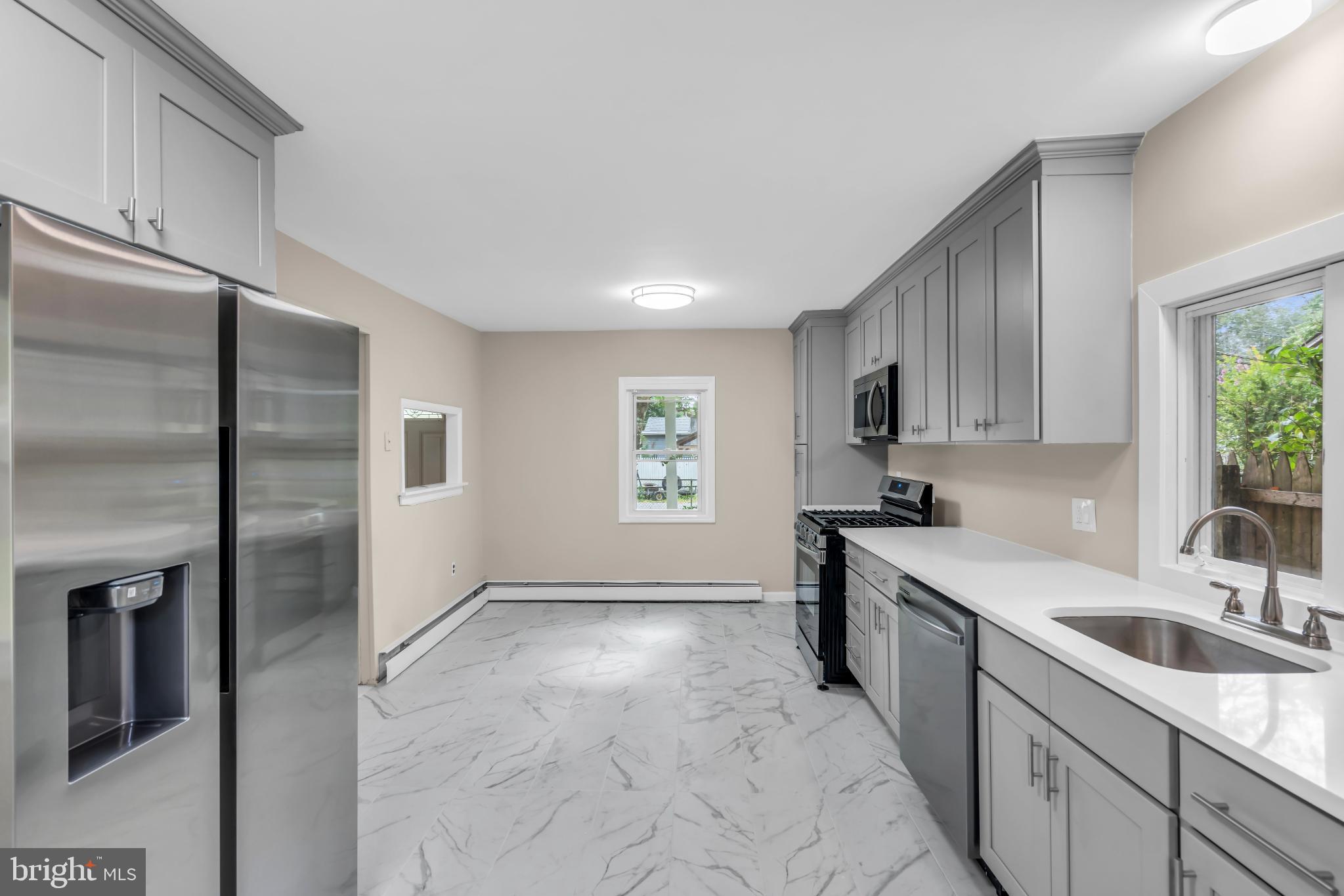102 Sunset Street Browns Mills, NJ 08015 - Photo 11 of 27 a kitchen with granite countertop a sink stainless steel appliances and cabinets