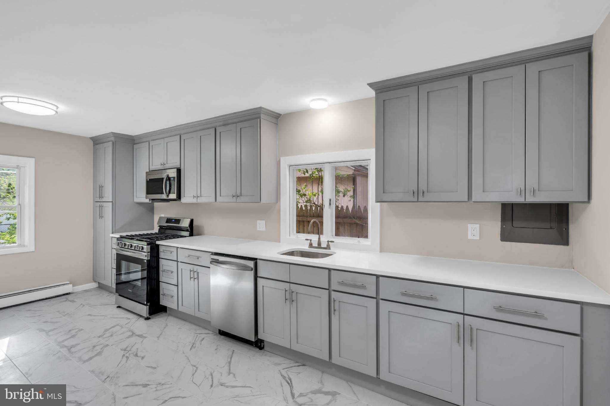102 Sunset Street Browns Mills, NJ 08015 - Photo 12 of 27 a kitchen with stainless steel appliances granite countertop white cabinets a sink and dishwasher