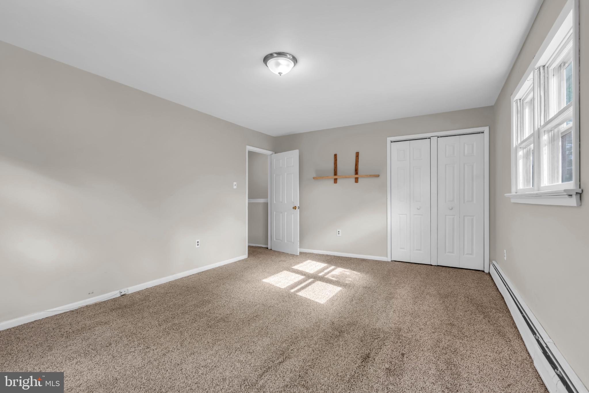 102 Sunset Street Browns Mills, NJ 08015 - Photo 19 of 27 a view of an empty room with a window