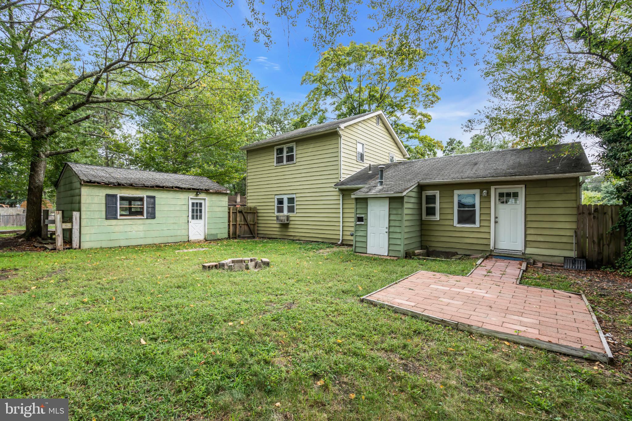 102 Sunset Street Browns Mills, NJ 08015 - Photo 25 of 27 a backyard of a house with table and chairs