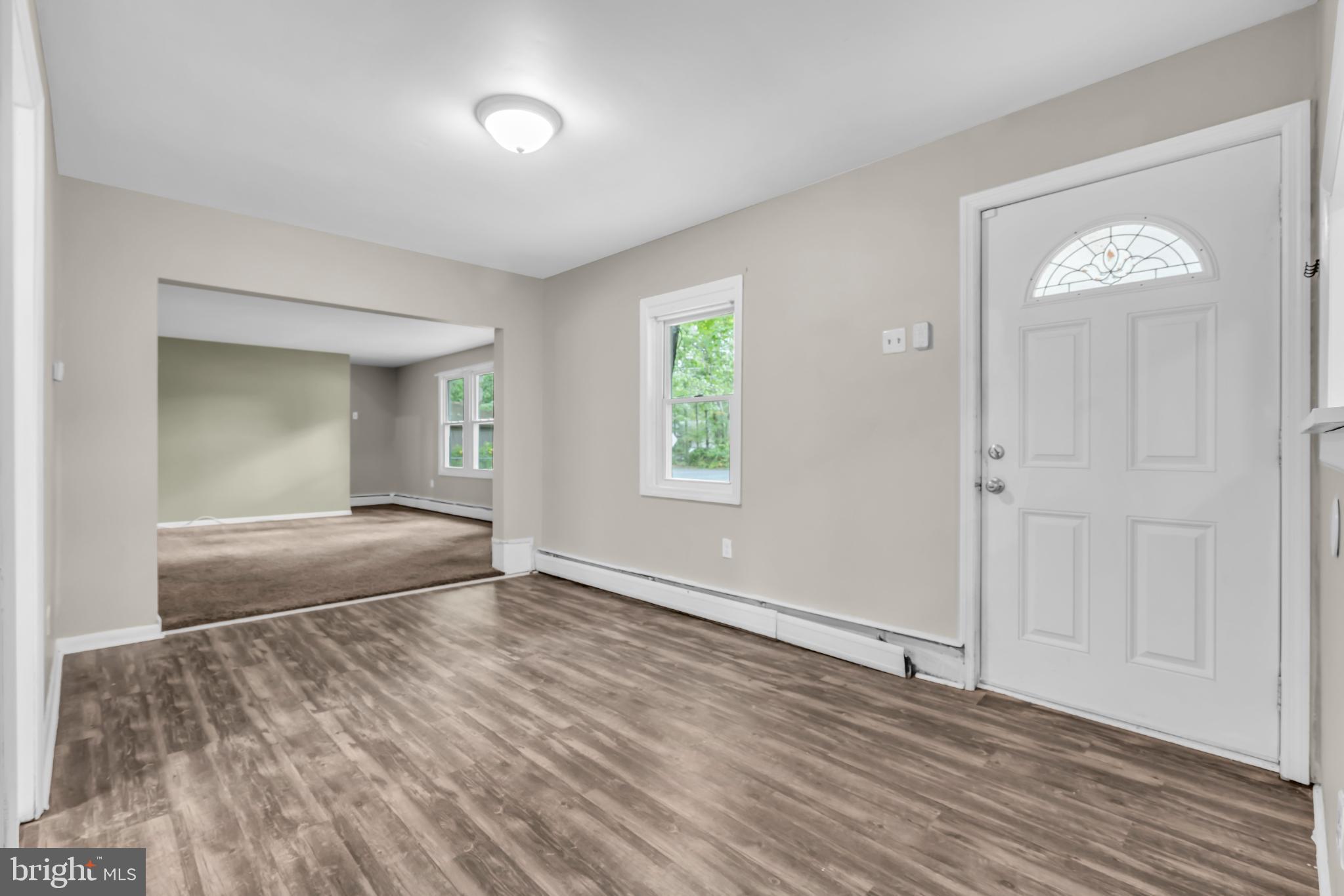 102 Sunset Street Browns Mills, NJ 08015 - Photo 6 of 27 an empty room with wooden floor and windows