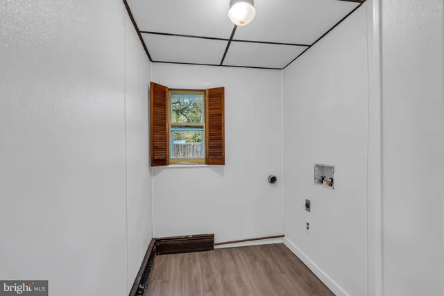 a view of a room with wooden floor and windows
