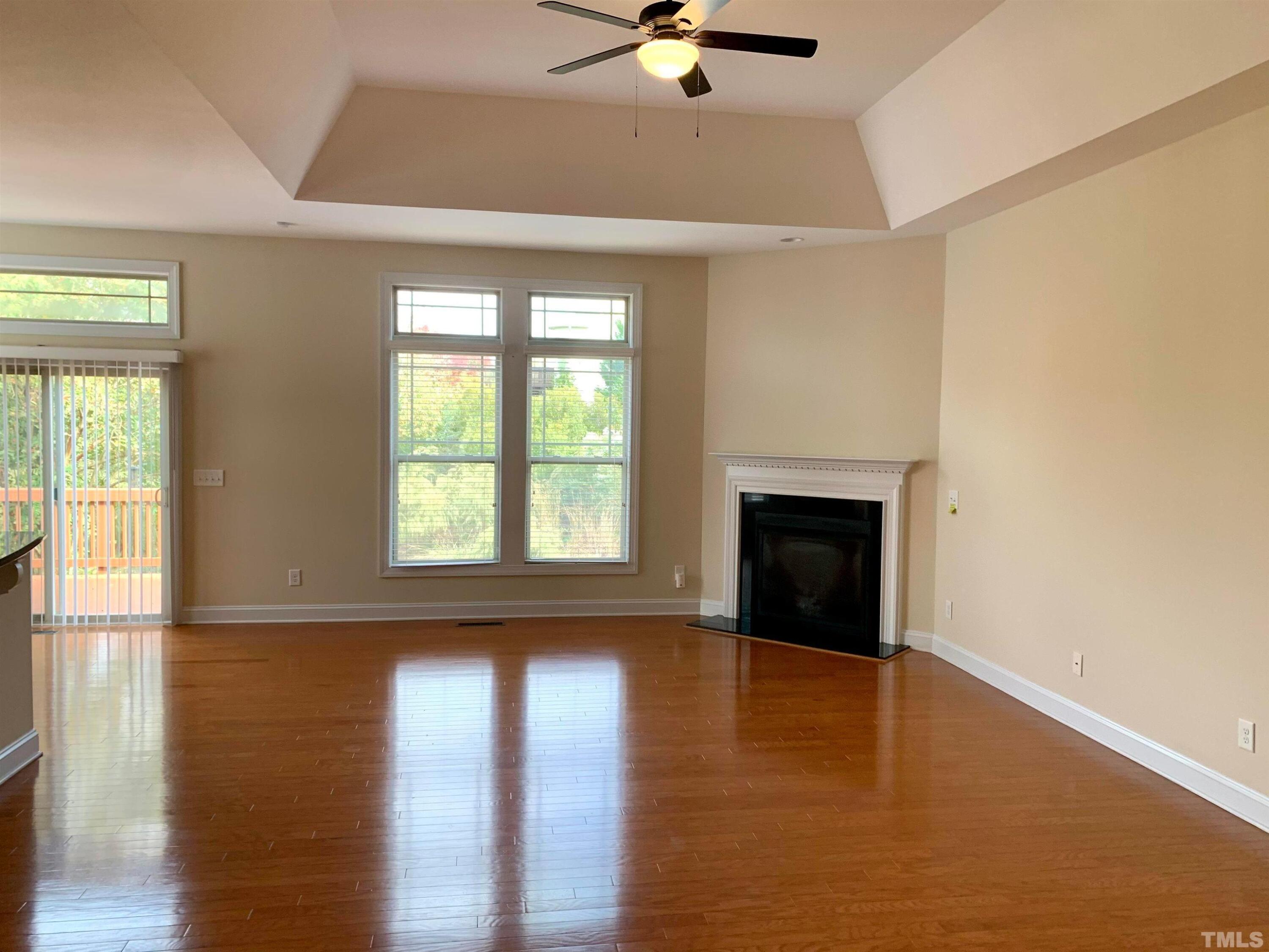 706 Weavers Ridge Drive Cary, NC 27519 - Photo 5 of 14 a view of an empty room with a window and wooden floor
