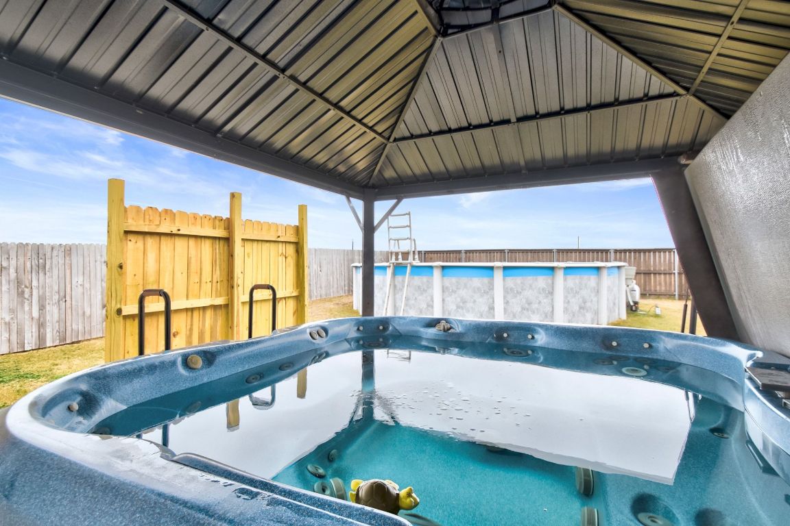 414 Plateau Street Maxwell, TX 78656 - Photo 20 of 25 a bathroom with a tub a sink and a large window