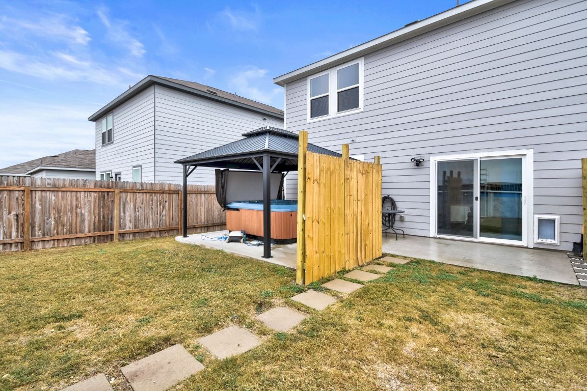 414 Plateau Street Maxwell, TX 78656 - Photo 23 of 25 a view of a house with backyard and wooden fence