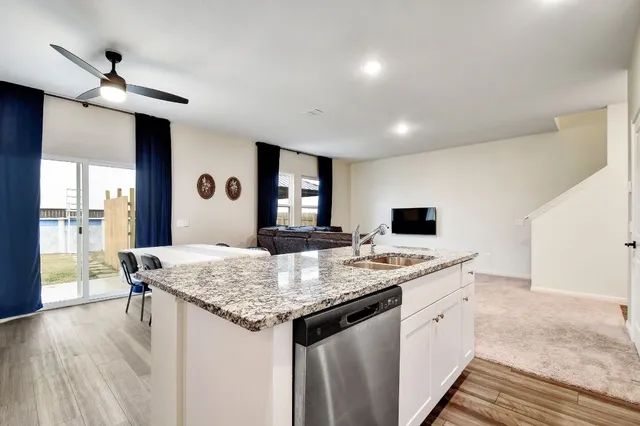 a kitchen with stainless steel appliances granite countertop a sink refrigerator and microwave