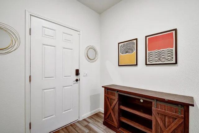 a kitchen with a counter top space a sink appliances and a large window
