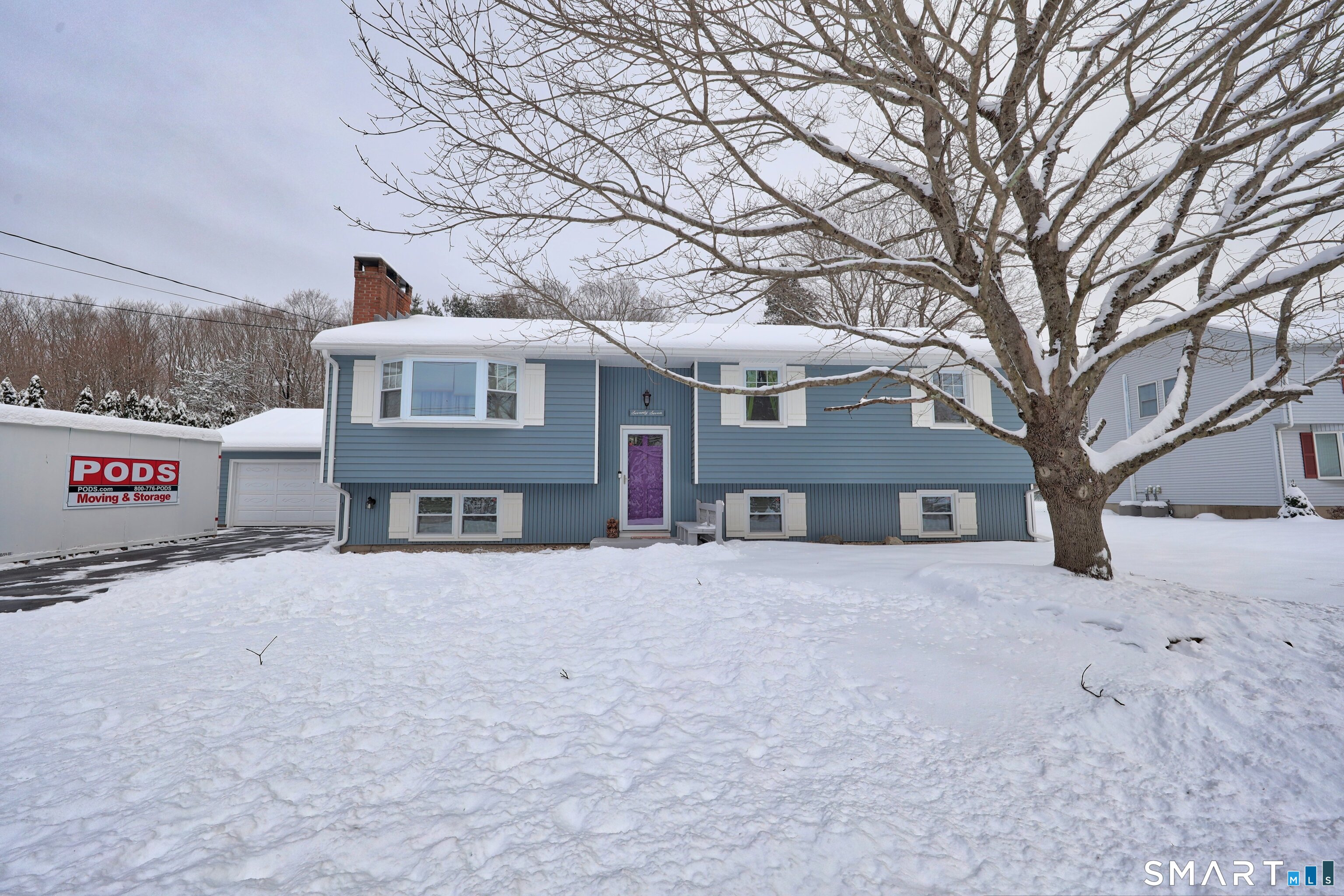 a view of a house with a snow in the yard