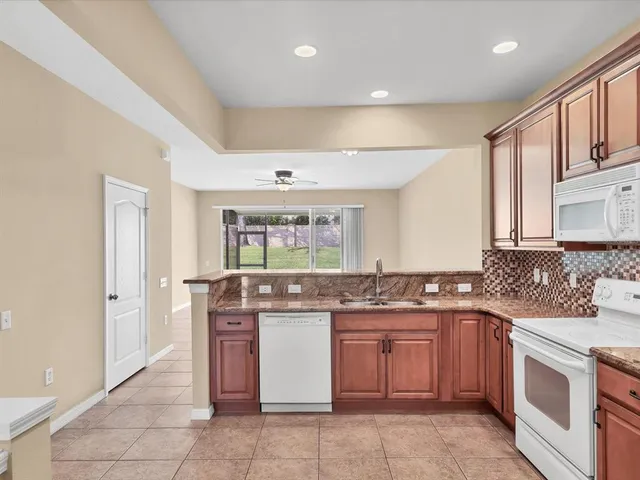 a kitchen with a stove top oven sink and cabinets