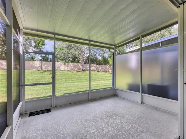 a view of an empty room with window front door