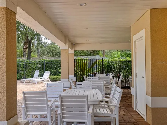 a view of a patio with couches chairs and wooden floor