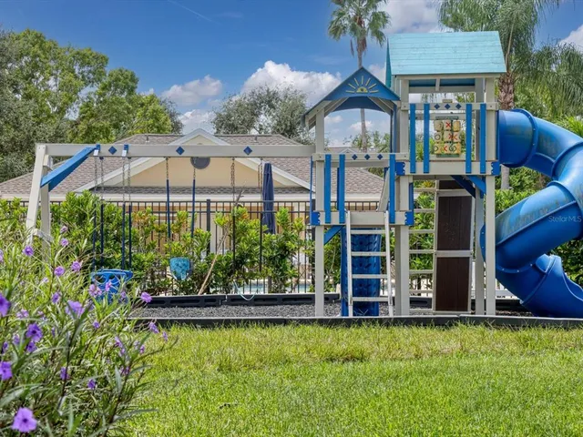 a front view of a house with swimming pool having outdoor seating