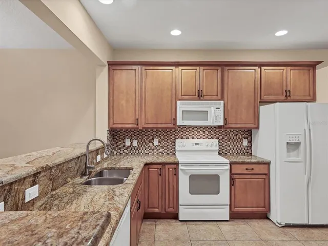 a kitchen with a stove top oven sink and cabinets