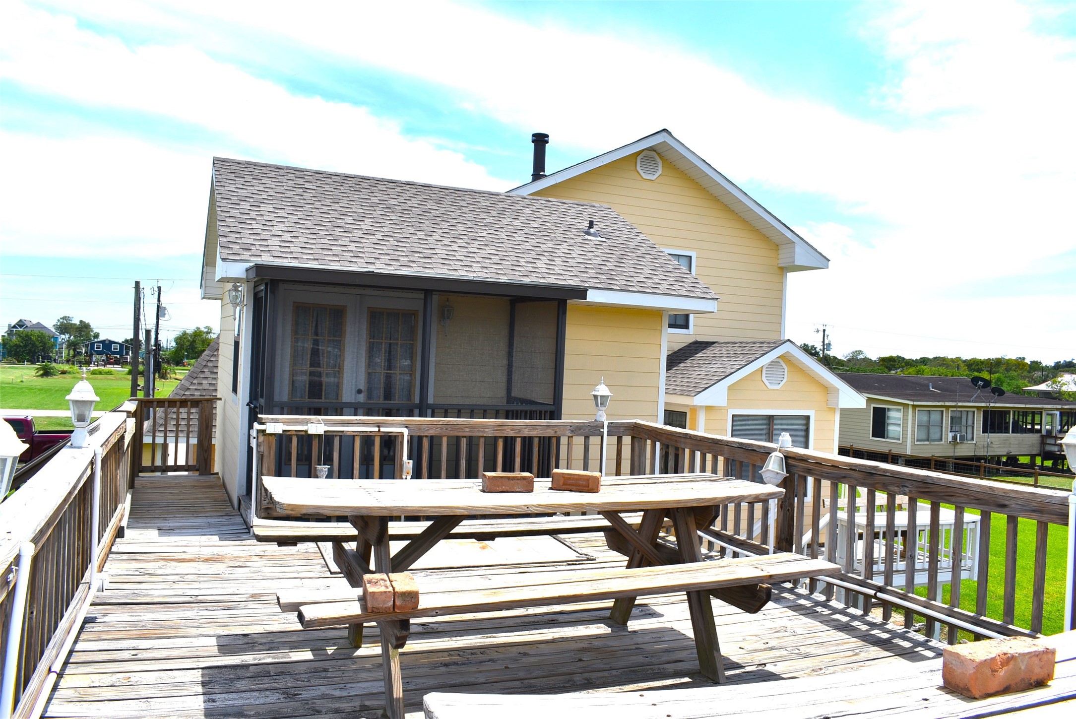 1657 County Road Sargent, TX 77414 - Photo 19 of 46 a view of a house with a wooden deck
