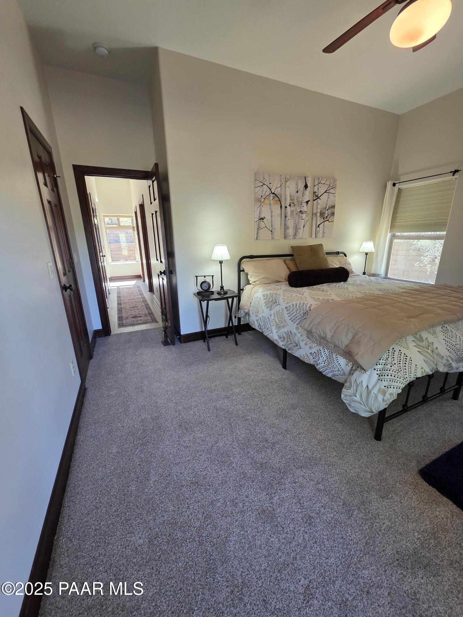 17180 West Model Creek Road Kirkland, AZ 86332 - Photo 20 of 53 a spacious bedroom with a bed and a window