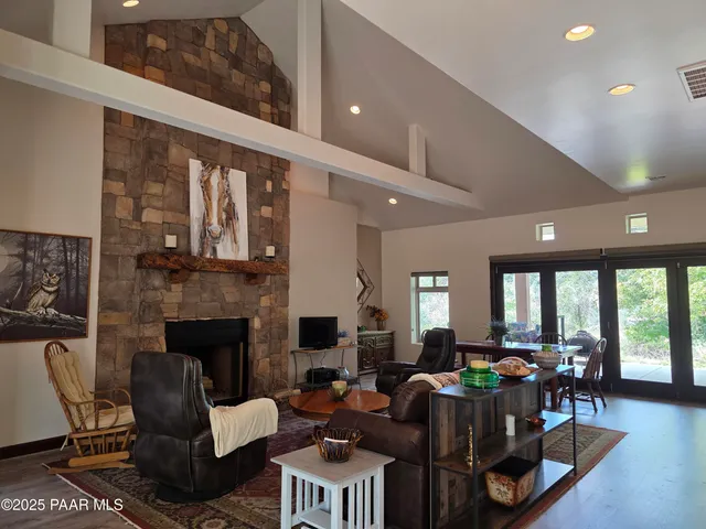 a living room with furniture a fireplace and a table