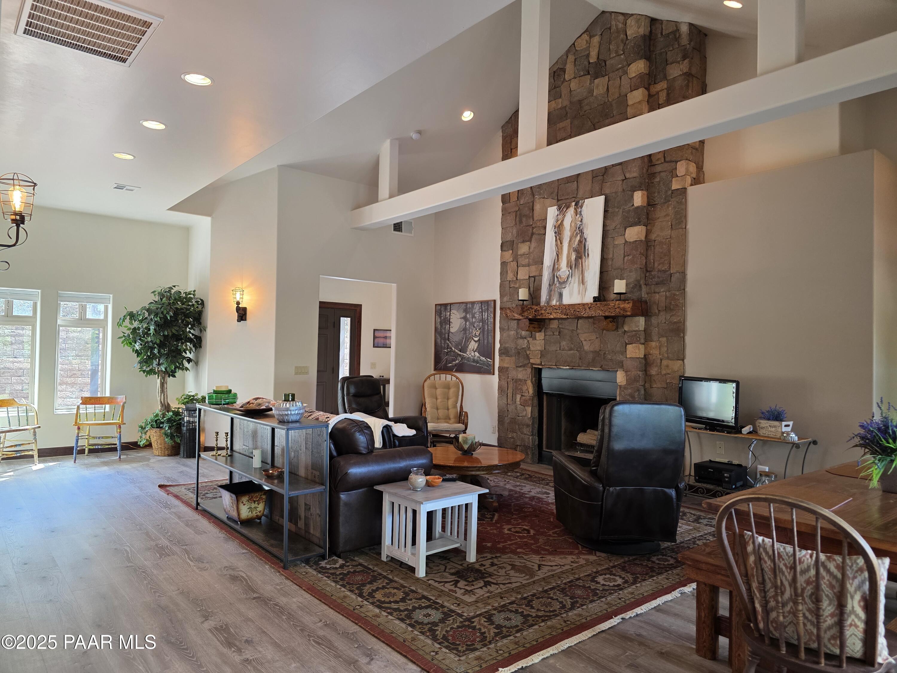 17180 West Model Creek Road Kirkland, AZ 86332 - Photo 8 of 53 a living room with furniture a fireplace and a table