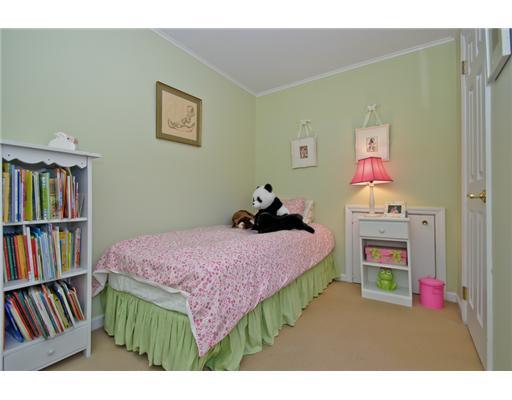35 Walmsley Road Darien, CT 06820 - Photo 11 of 17 a bedroom with a bed and a book shelf