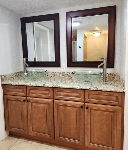 a view of mirror and cabinets