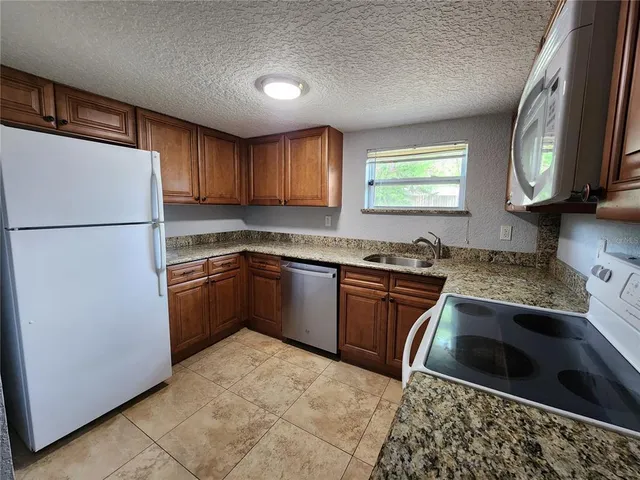 a kitchen with a refrigerator sink and stove