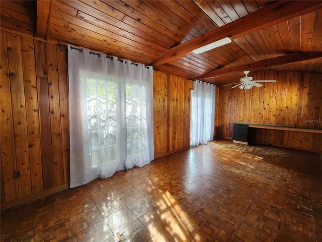 a view of empty room with wooden walls