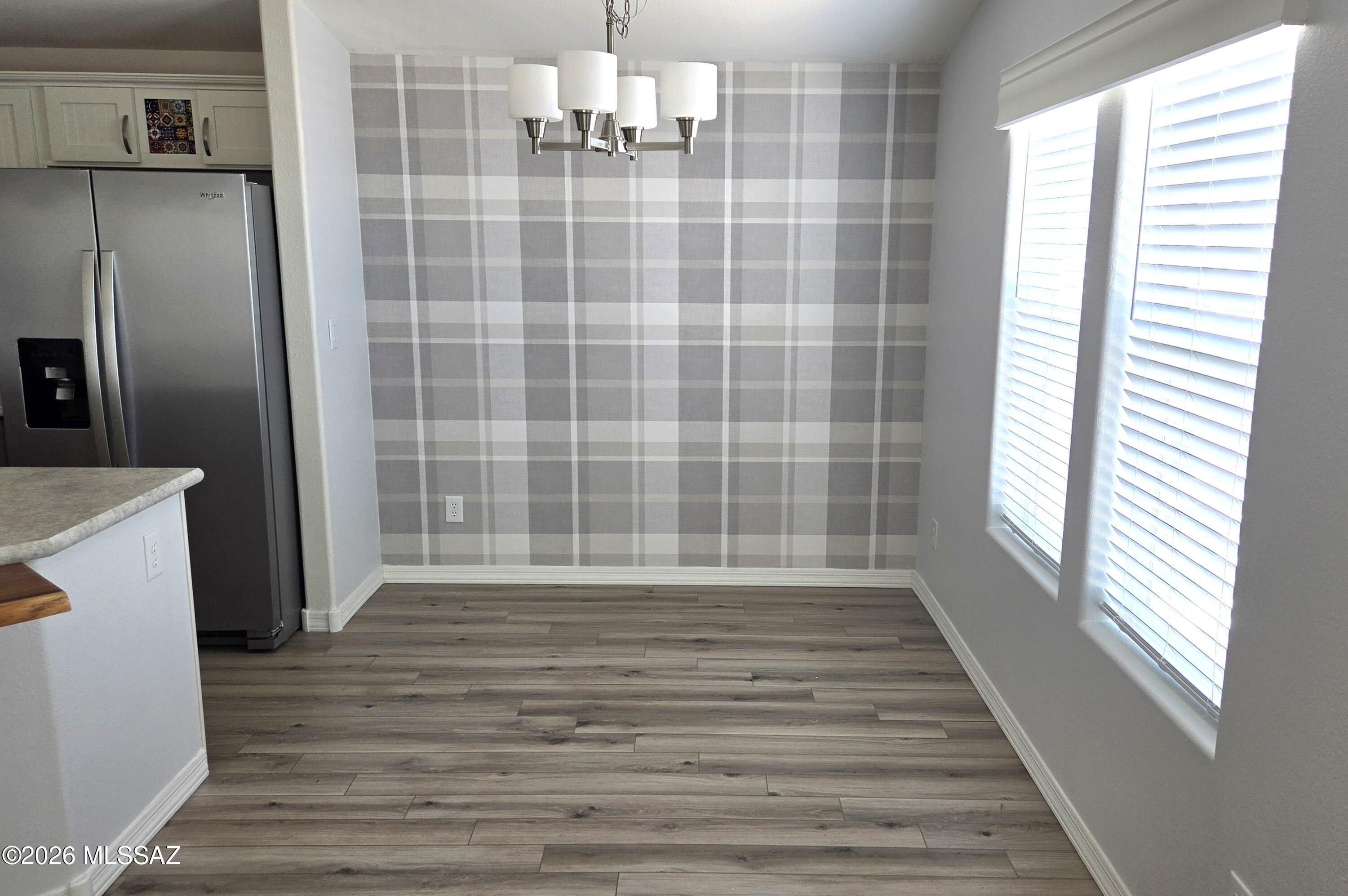 1030 Barrel Cactus Ridge, Unit 118 Benson, AZ 85602 - Photo 12 of 22 a view of wooden floor and windows in a room