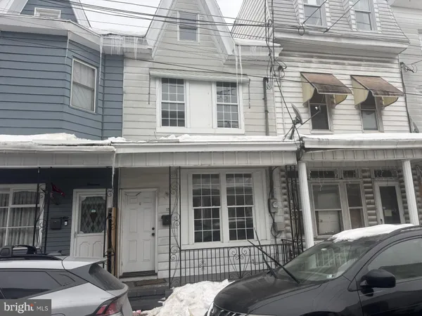 a front view of a house with a parking space