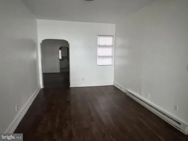 an empty room with wooden floor and closet